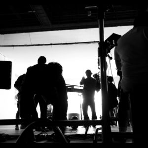Silhoutte images of video production and lighting set for filming which movie crew team working and