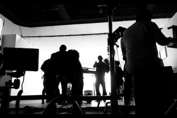 Silhoutte images of video production and lighting set for filming which movie crew team working and